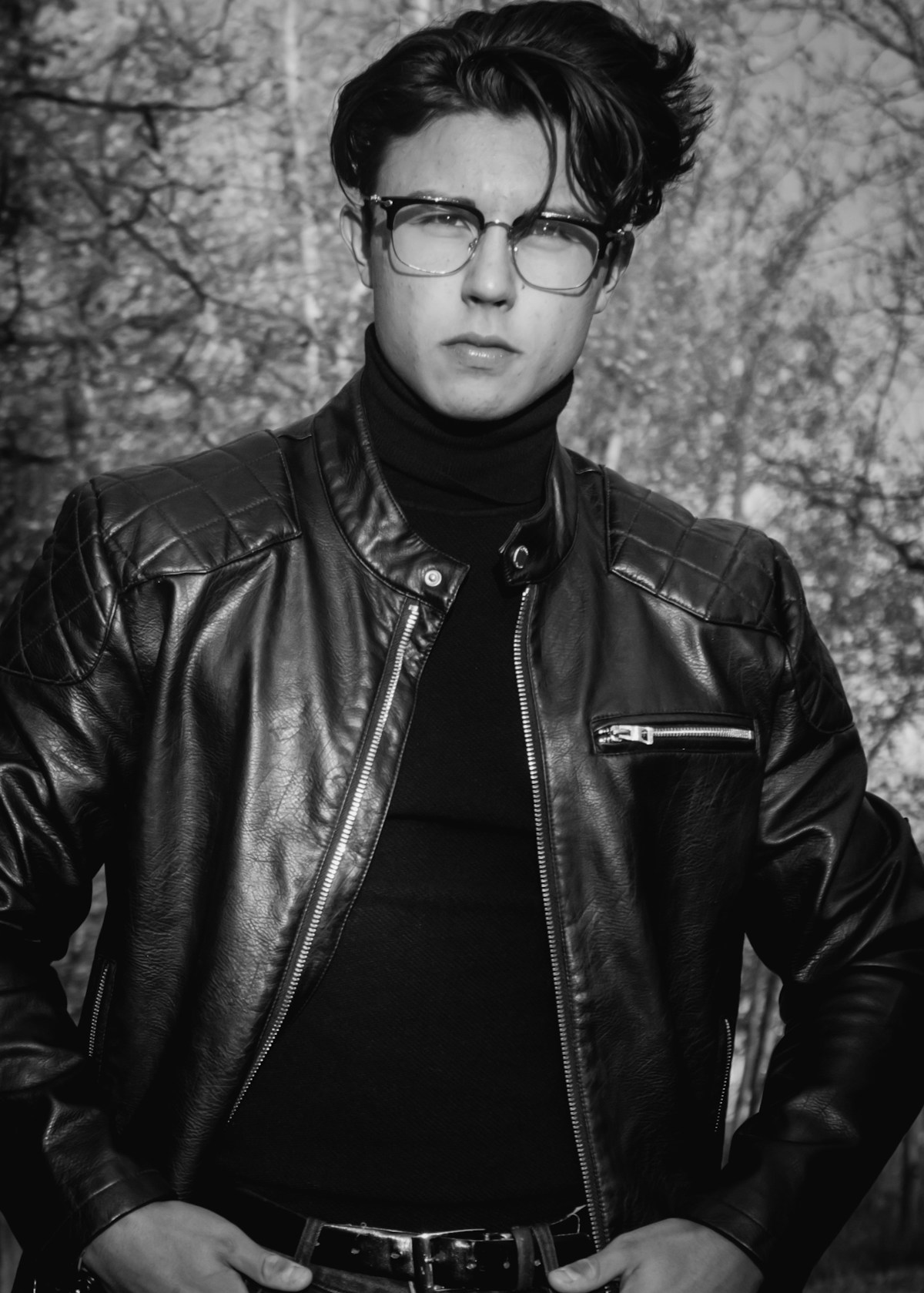 Male model wearing a premium black leather jacket — editorial fashion