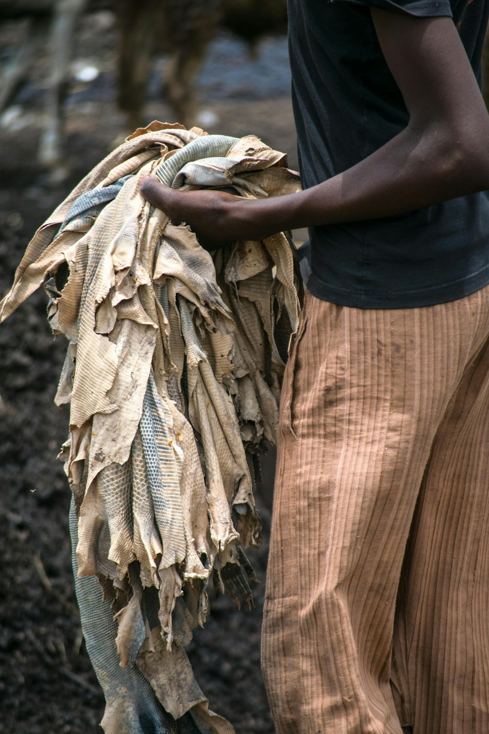 Artisan handling premium brown leather textile in a finishing workshop
